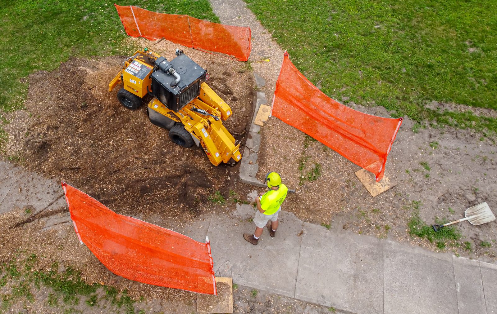 Stump grinder working a stump down below grade